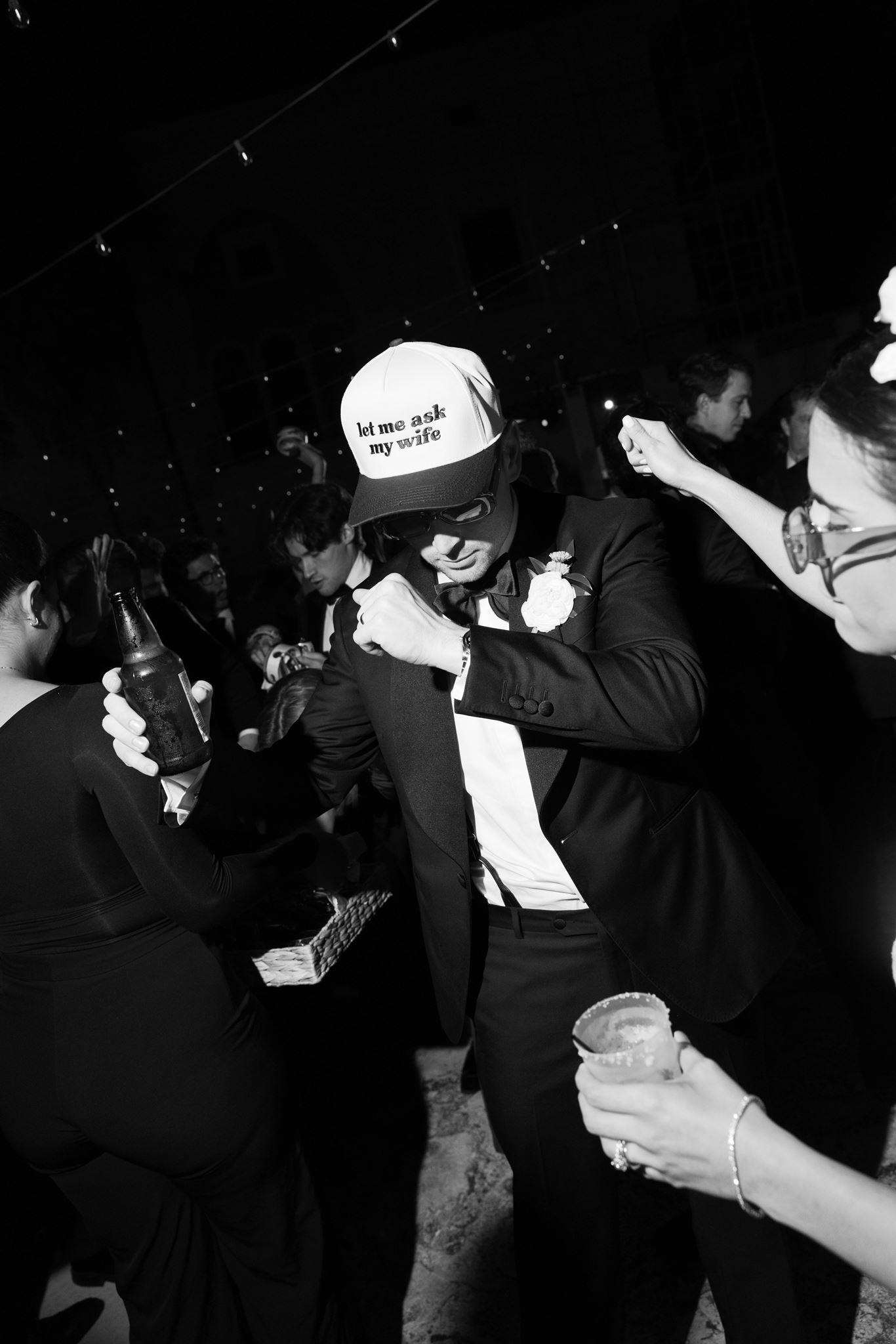Luke in a white hora loca cap dancing in black and white