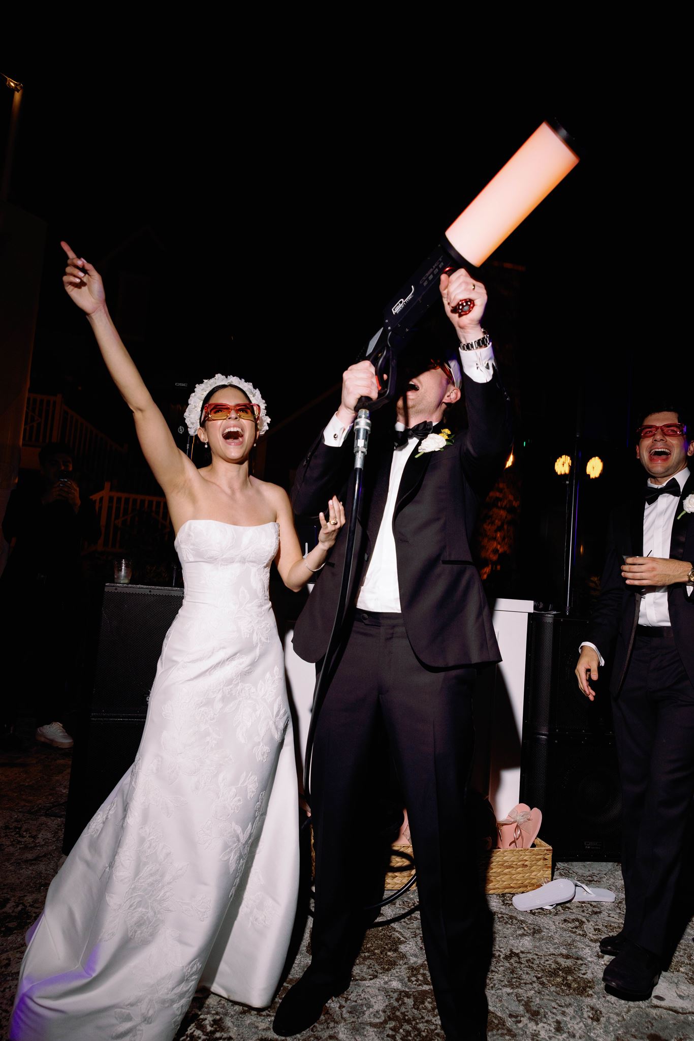 Ashley cheering as Luke fires a smoke gun during the hora loca