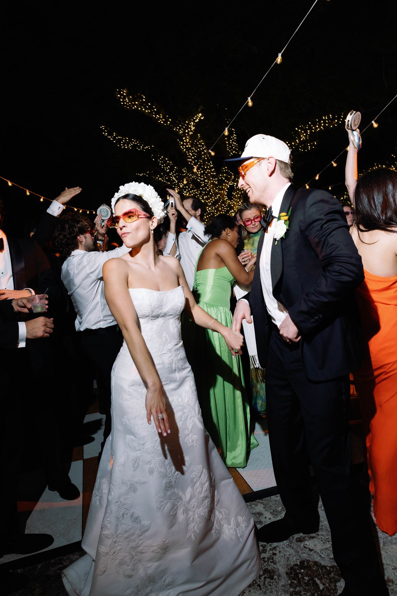 Ashley dancing in her wedding dress as Luke wears a white cap
