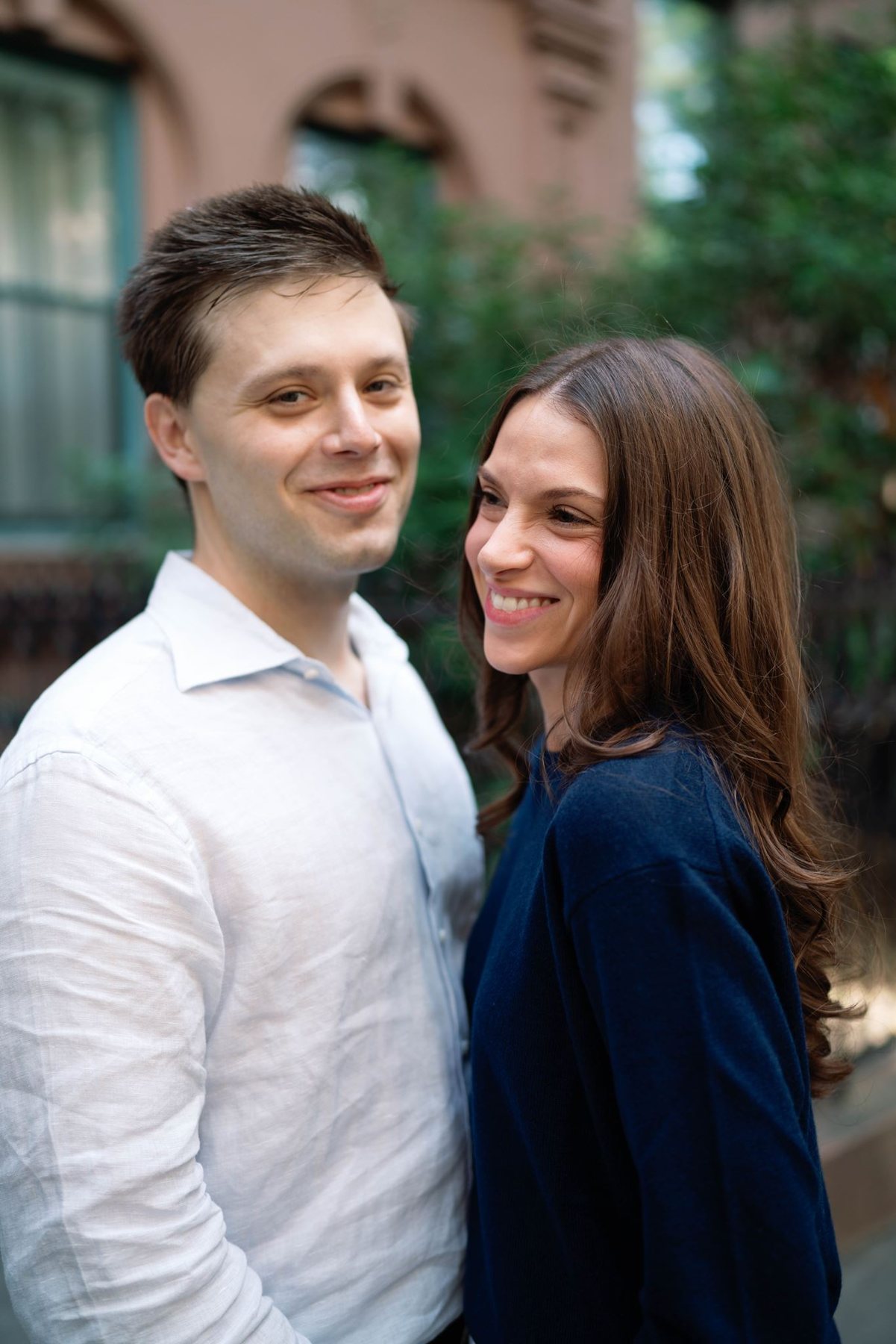 Close portrait of Jeremy and Haley smiling at each other, Haley in a navy sweater