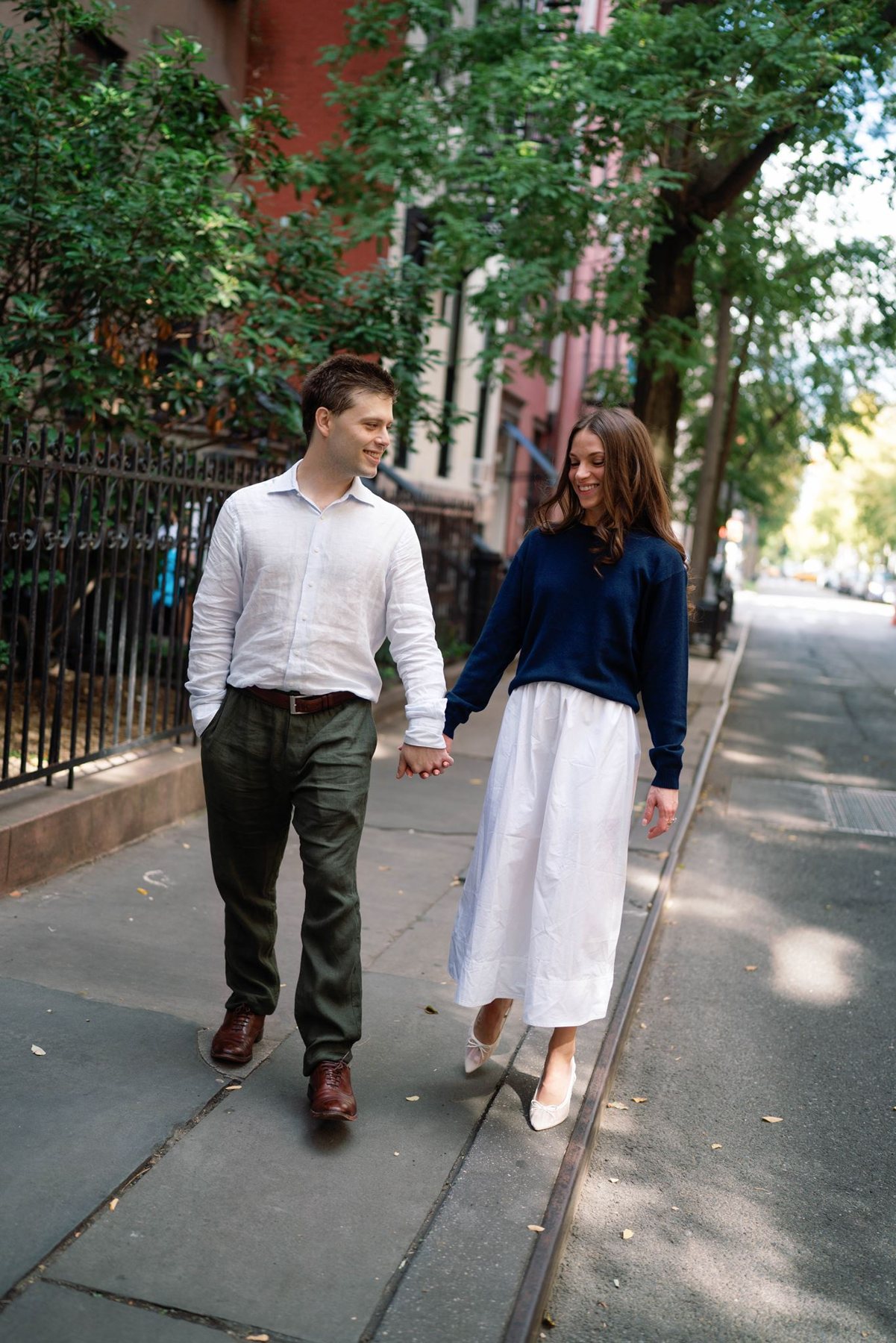 Haley laughing as she walks with Jeremy down a quiet street in New York City